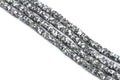Several strands of white and gray polymer clay disc beads, arranged diagonally on a white background.
