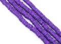 four strands of dark speckled purple polymer clay disc beads on a white background.