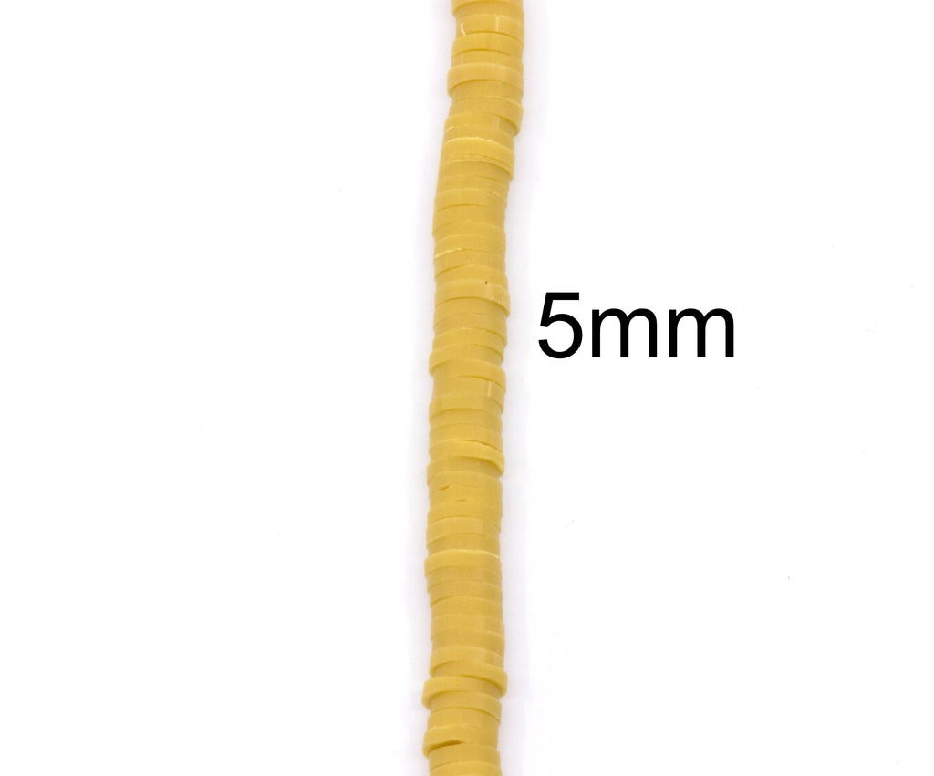 A close-up of a single strand of mustard yellow polymer clay disc beads arranged vertically on a white background, with the text '5mm' overlaid to indicate the size.