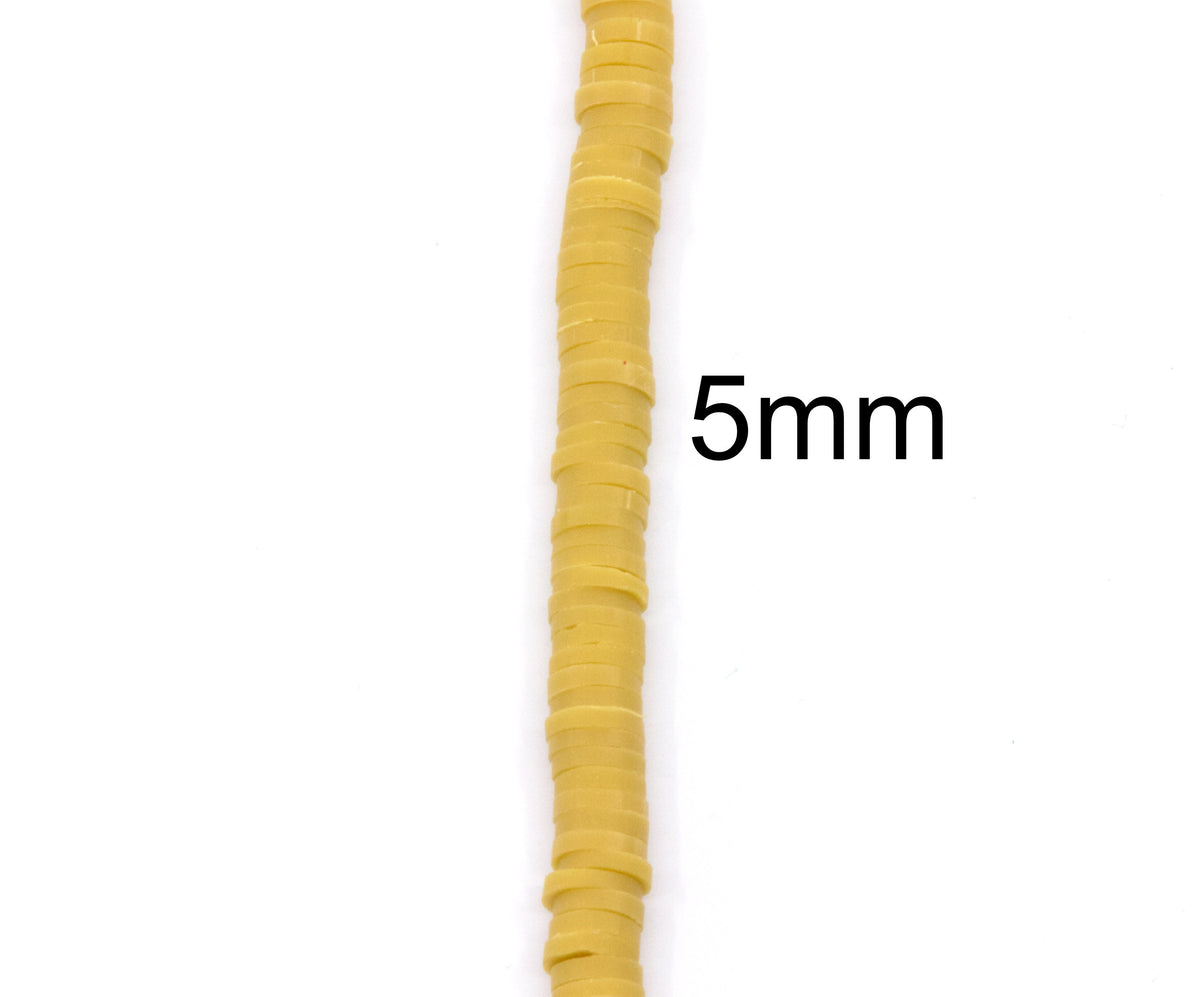 A close-up of a single strand of mustard yellow polymer clay disc beads arranged vertically on a white background, with the text '5mm' overlaid to indicate the size.