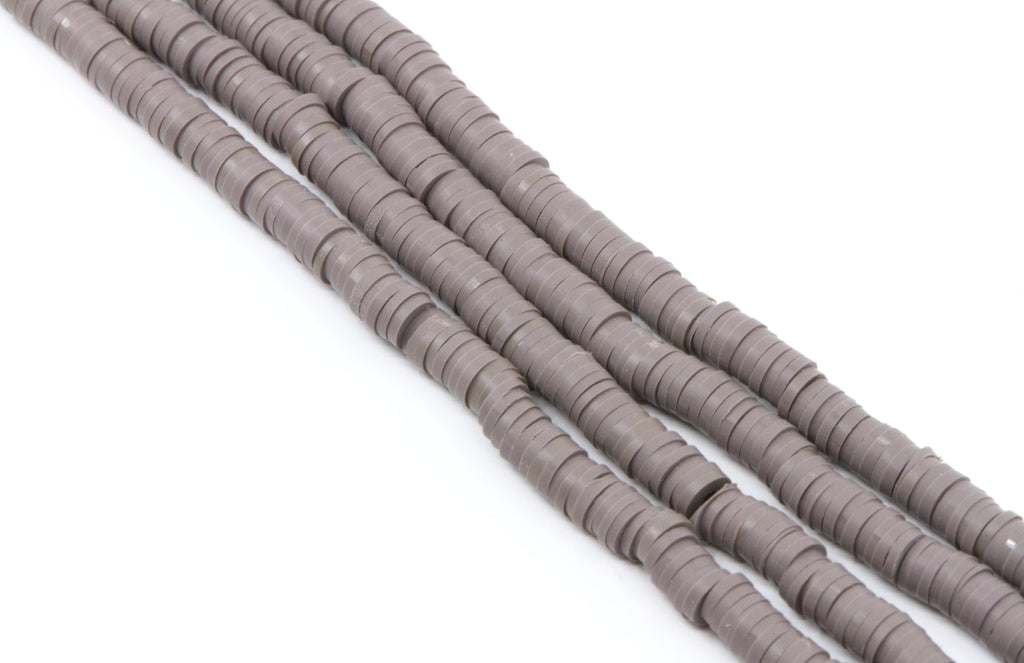 Four strands of gray polymer clay disc beads arranged diagonally on a plain white background.