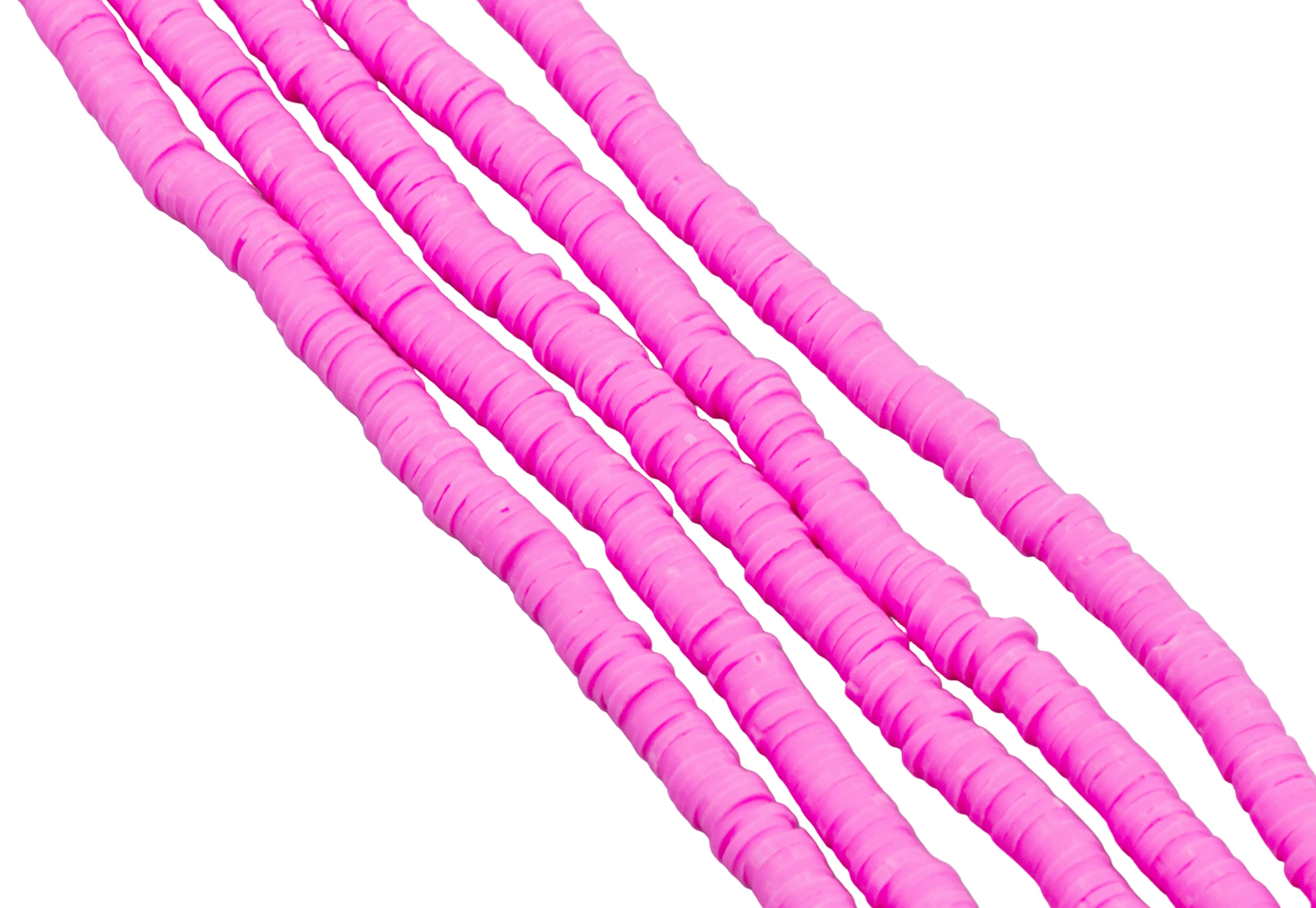 multiple strands of pink polymer clay disc beads arranged diagonally on a plain white background.