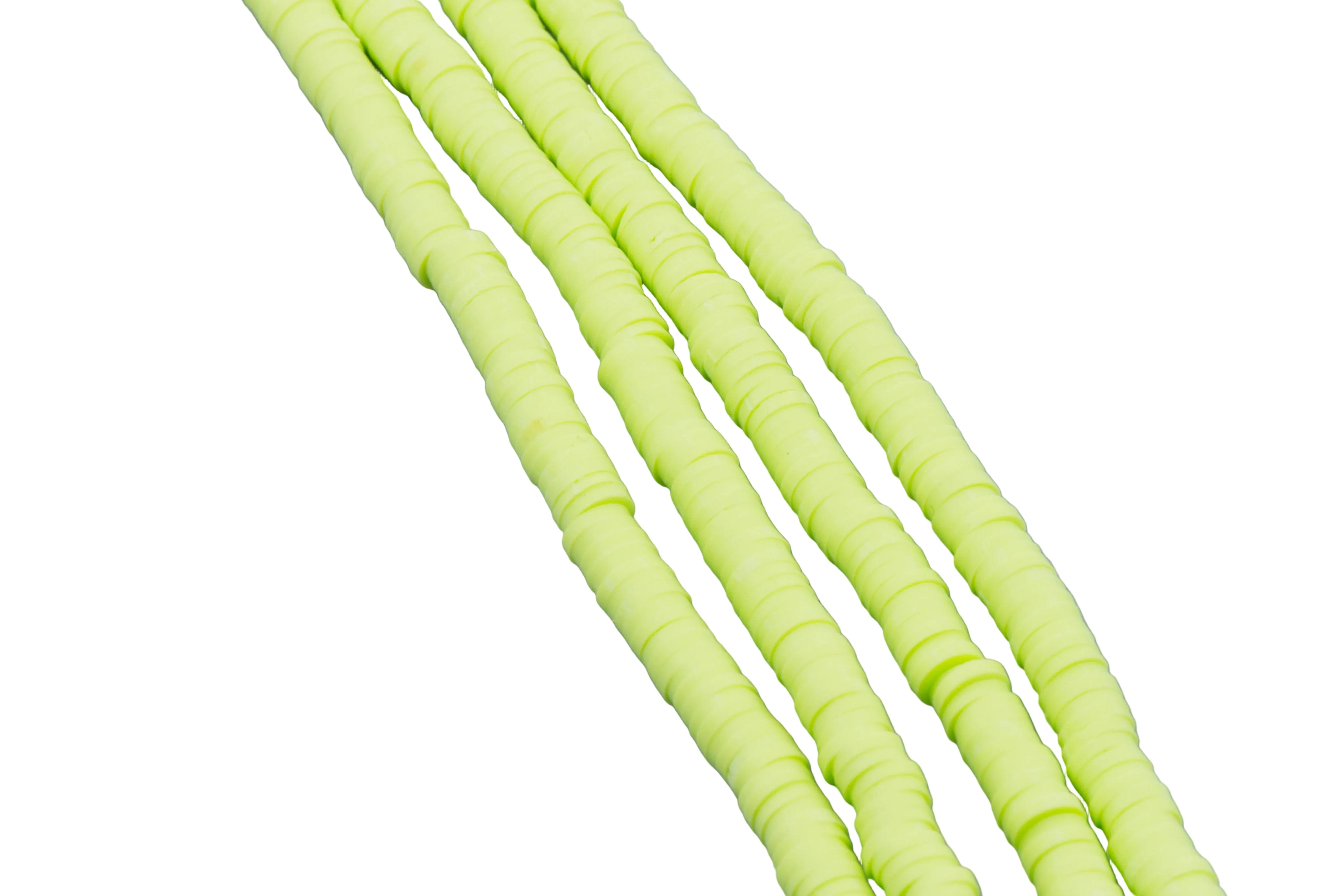 four strands of green polymer clay beads shown diagonally on a white background 