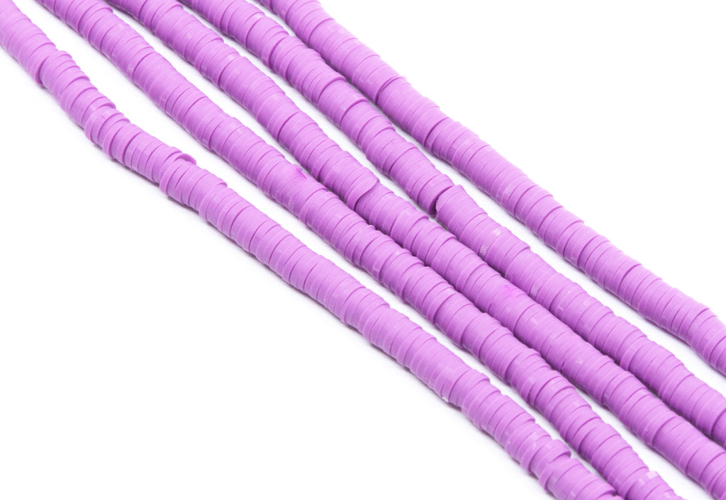 multiple strands of purple polymer clay disc beads shown diagonally on a plain white background.