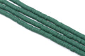 Four strands of dark green polymer clay disc beads arranged diagonally on a plain white background.