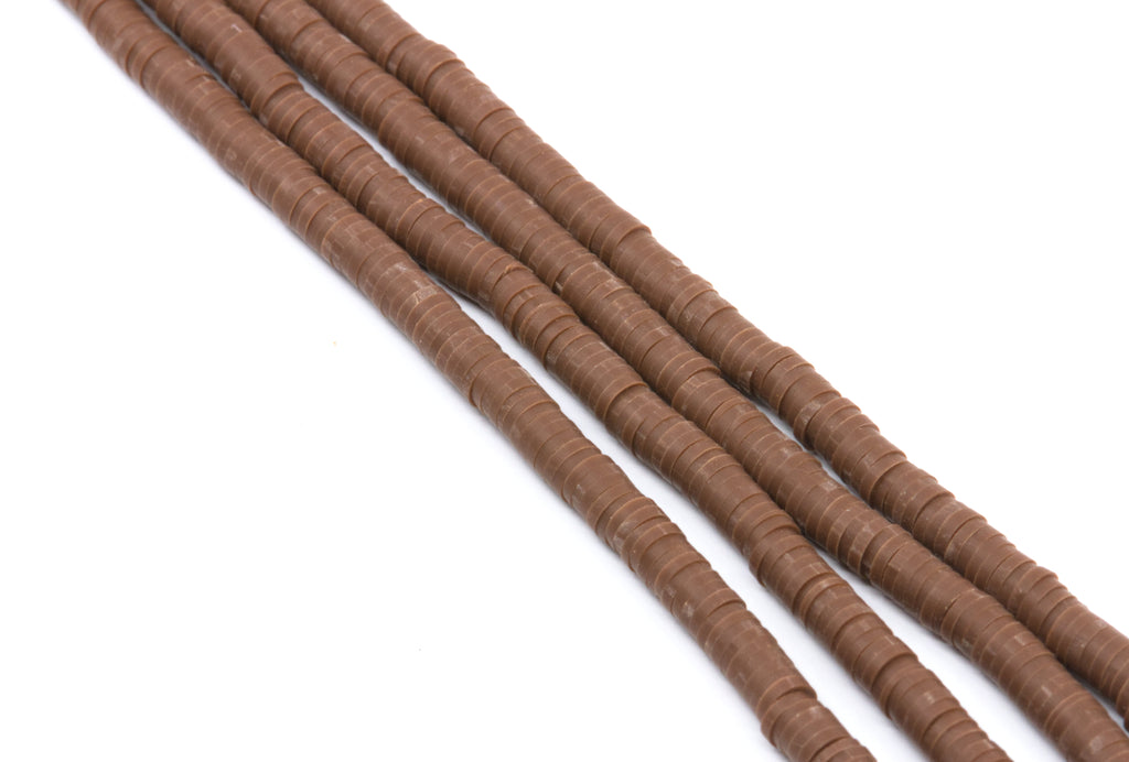 Four strands of brown polymer clay disc beads  arranged diagonally on a plain white background.