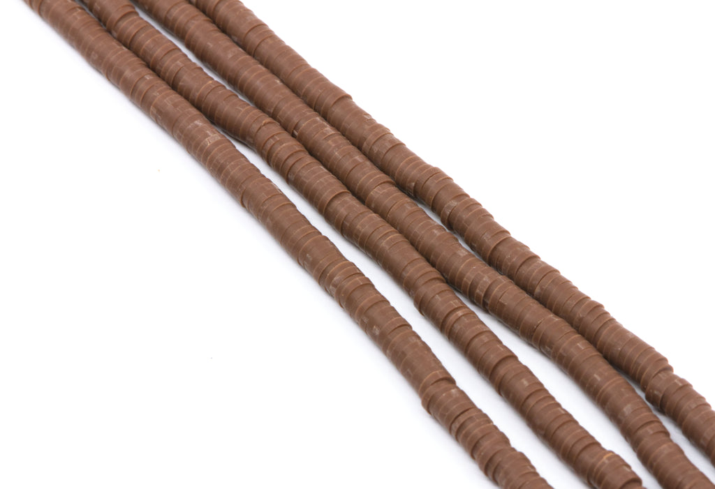 Four strands of brown polymer clay disc beads  arranged diagonally on a plain white background.