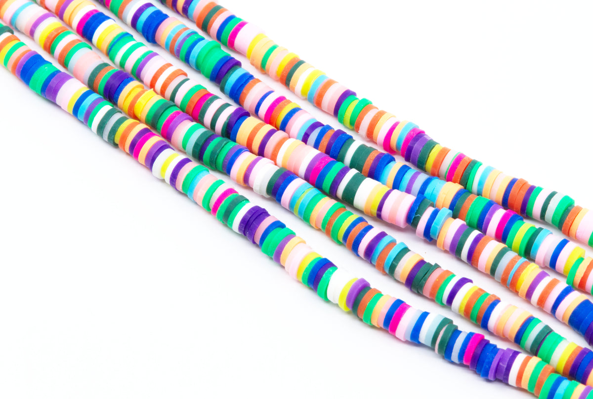 Four strands of colorful rainbow polymer clay disc beads arranged diagonally on a plain white background.