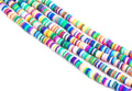 Four strands of colorful rainbow polymer clay disc beads arranged diagonally on a plain white background.