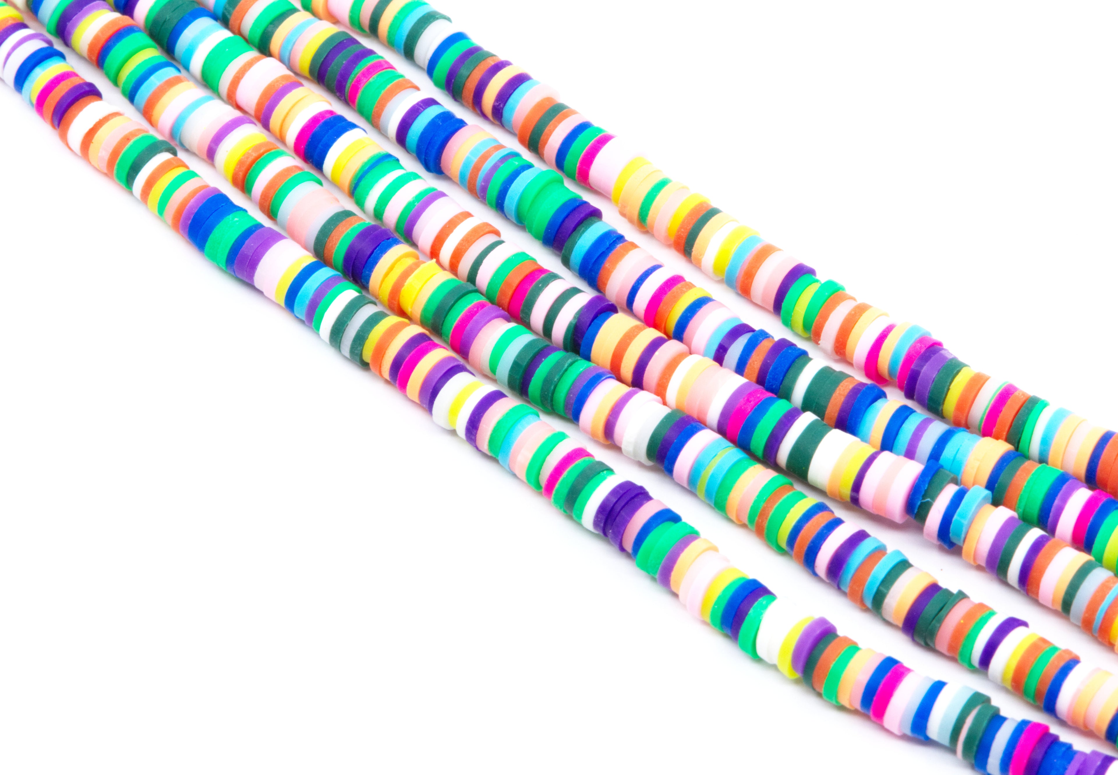 Four strands of colorful rainbow polymer clay disc beads arranged diagonally on a plain white background.