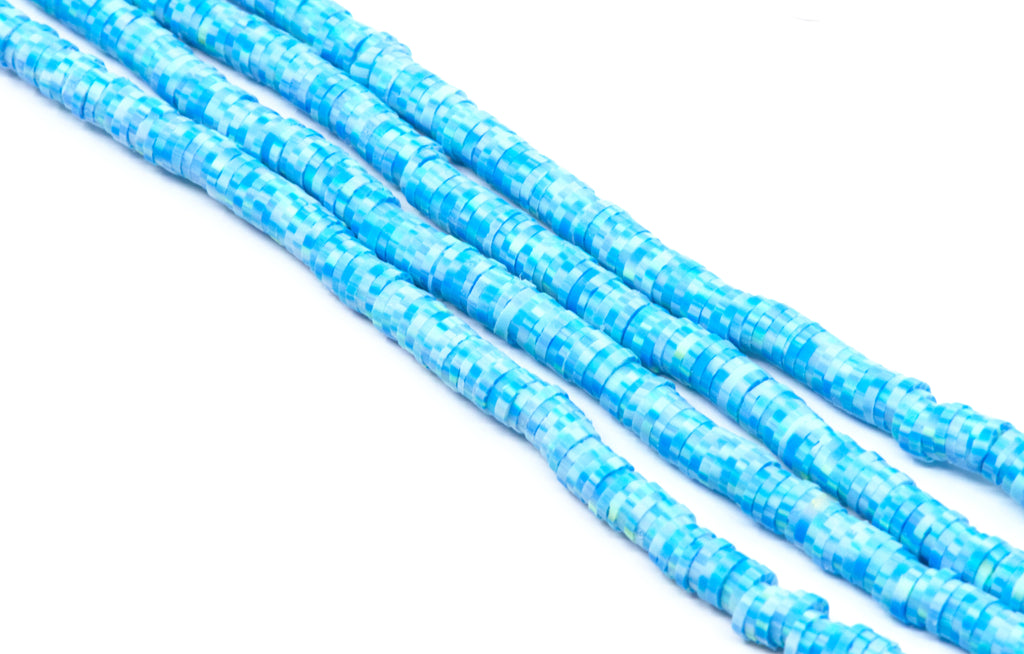 Four strands of blue polymer clay disc beads shown diagonally and  photographed on a clean white background.