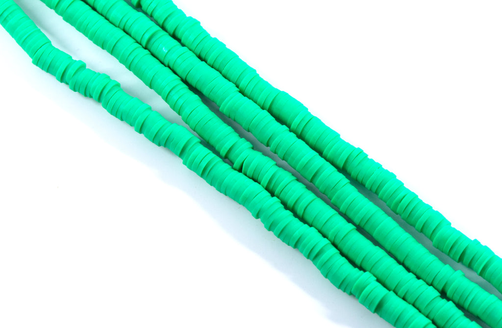 four strands of green polymer clay beads displayed on a white background.