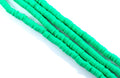 four strands of green polymer clay beads displayed on a white background.