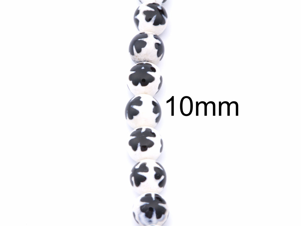 A vertical strand of round white beads with blue clover-like  patterns, shown on a plain white background with a black '10mm' size marker.