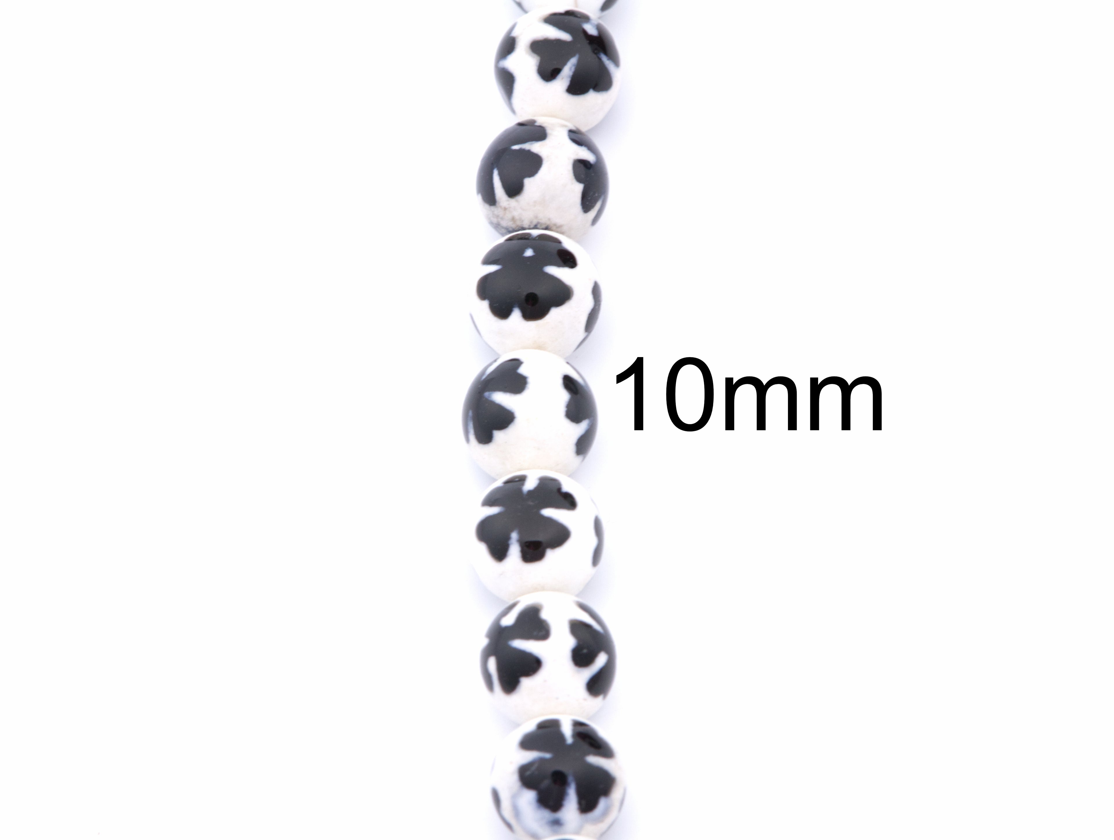 A vertical strand of round white beads with blue clover-like  patterns, shown on a plain white background with a black '10mm' size marker.