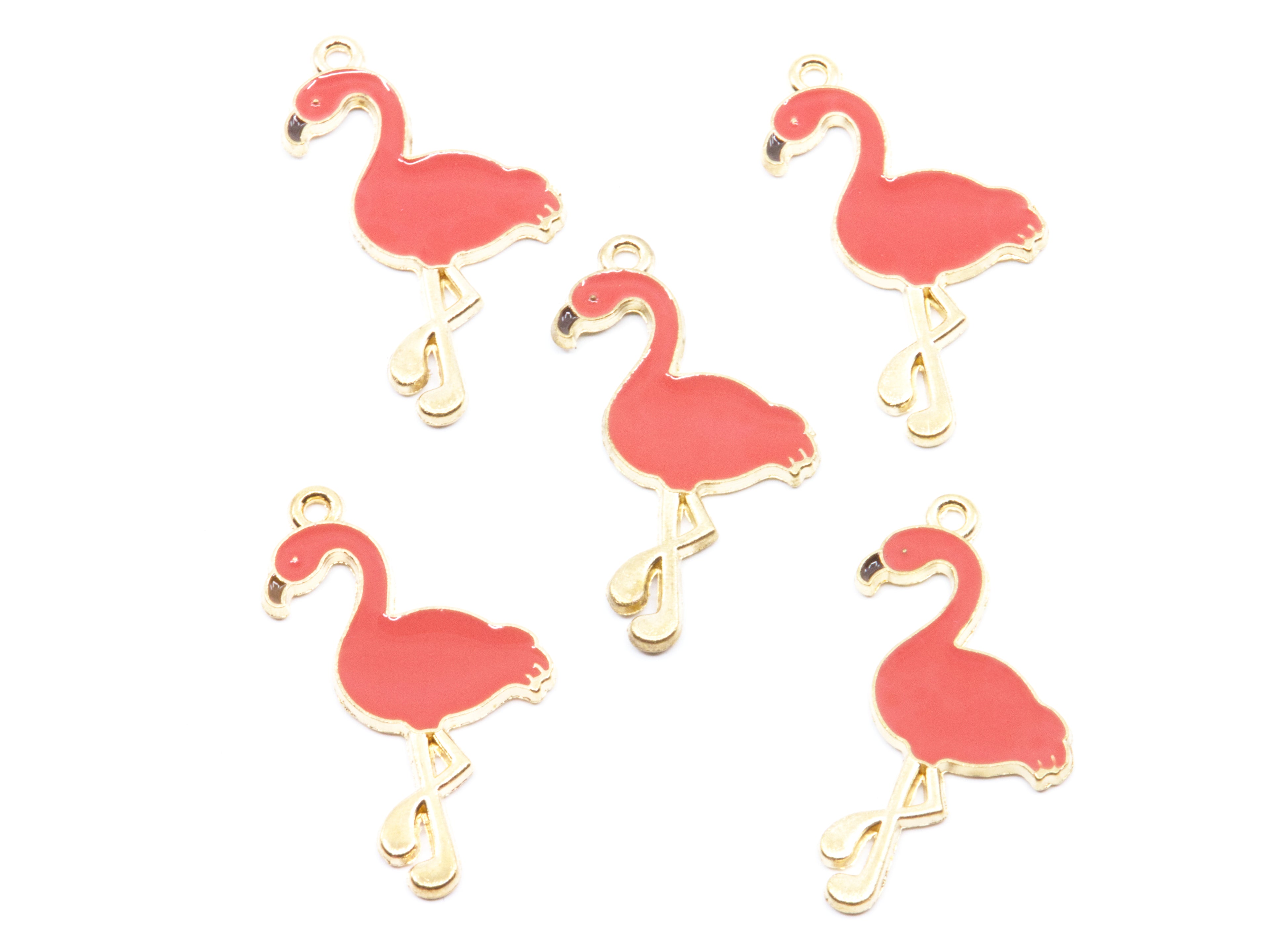 Five coral flamingo-shaped jewelry charms with gold-tone metal outlines and loops, arranged on a plain white background.