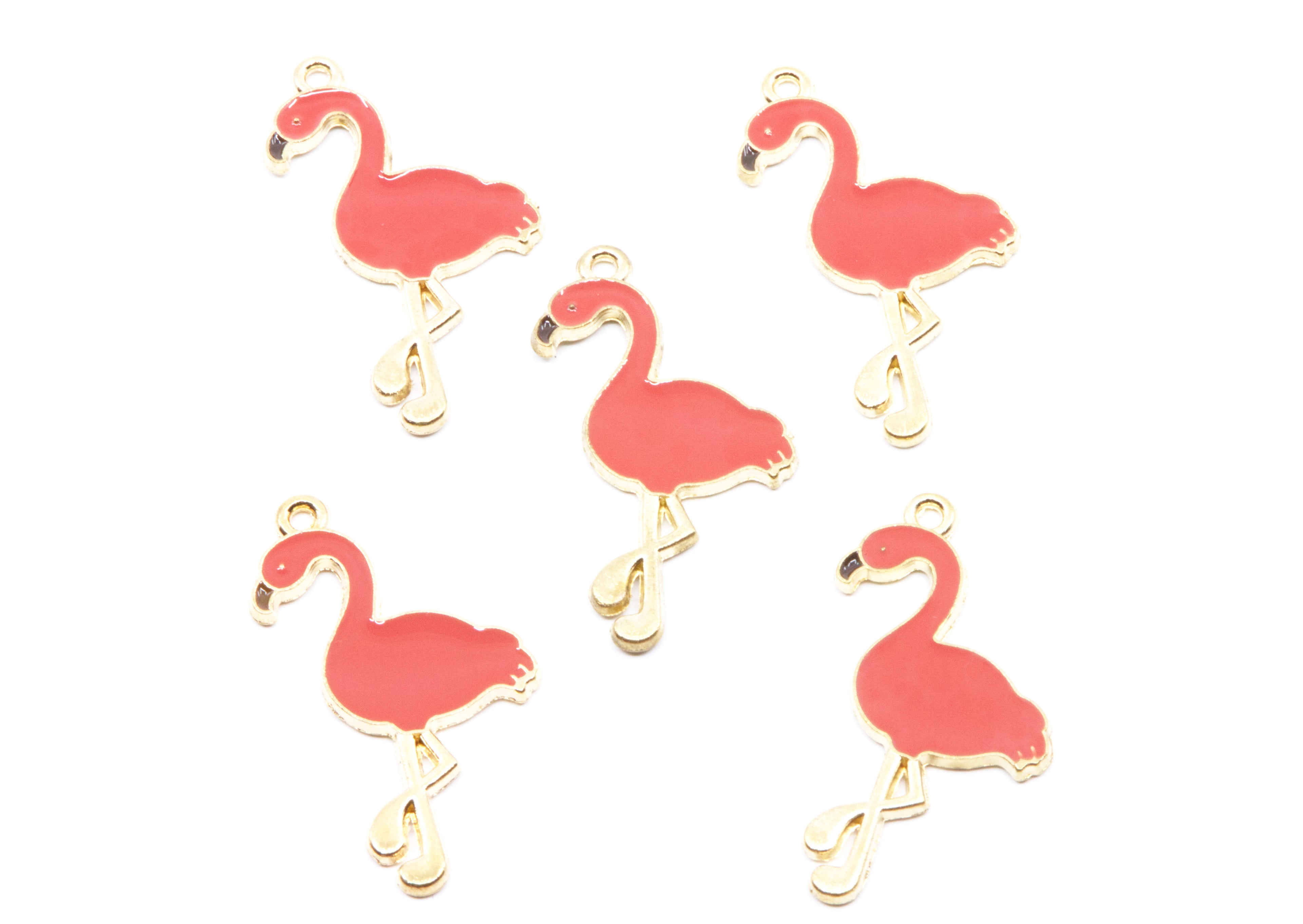 Five coral flamingo-shaped jewelry charms with gold-tone metal outlines and loops, arranged on a plain white background.