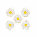 Five white daisy flower charms with yellow centers and gold-tone metal edges, arranged on a white background.