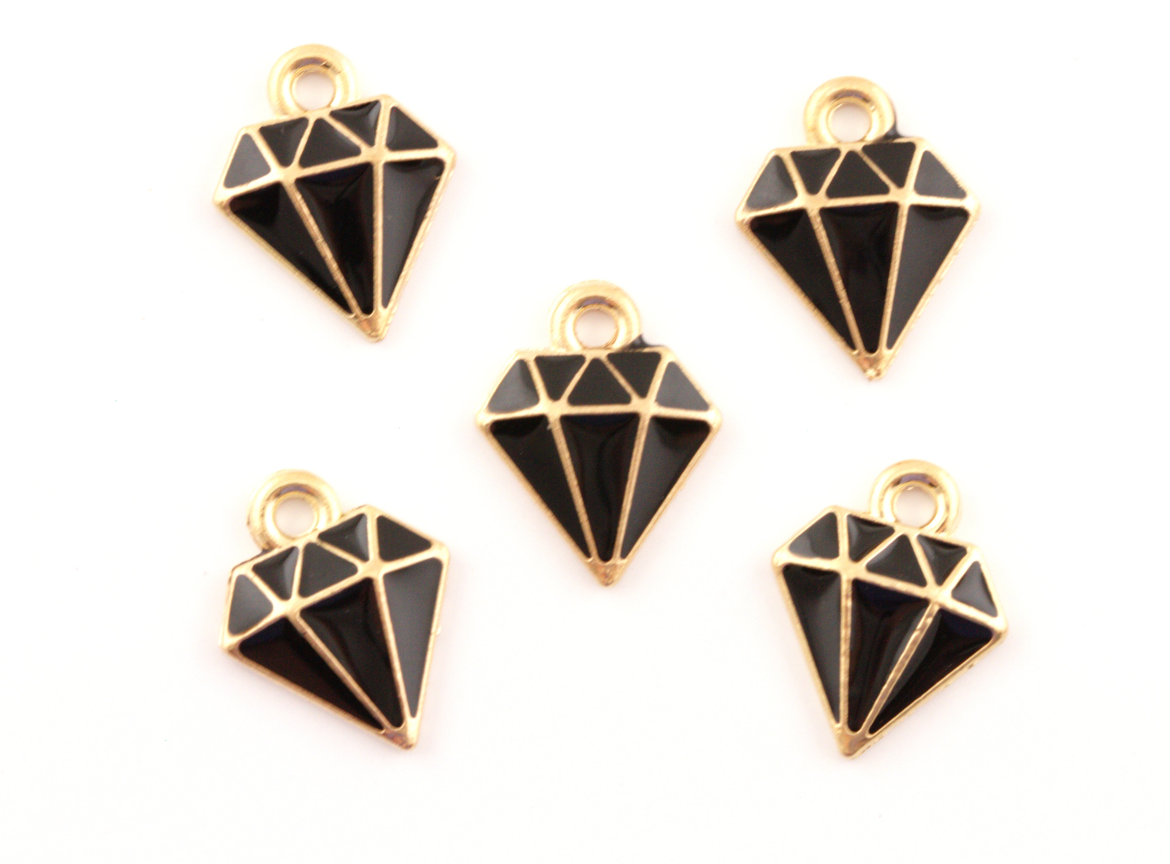 Five black and gold diamond-shaped jewelry charms with cutout facets, arranged on a plain white background.