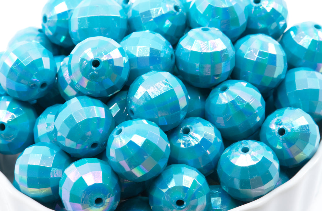 light blue faceted beads in a white bowl