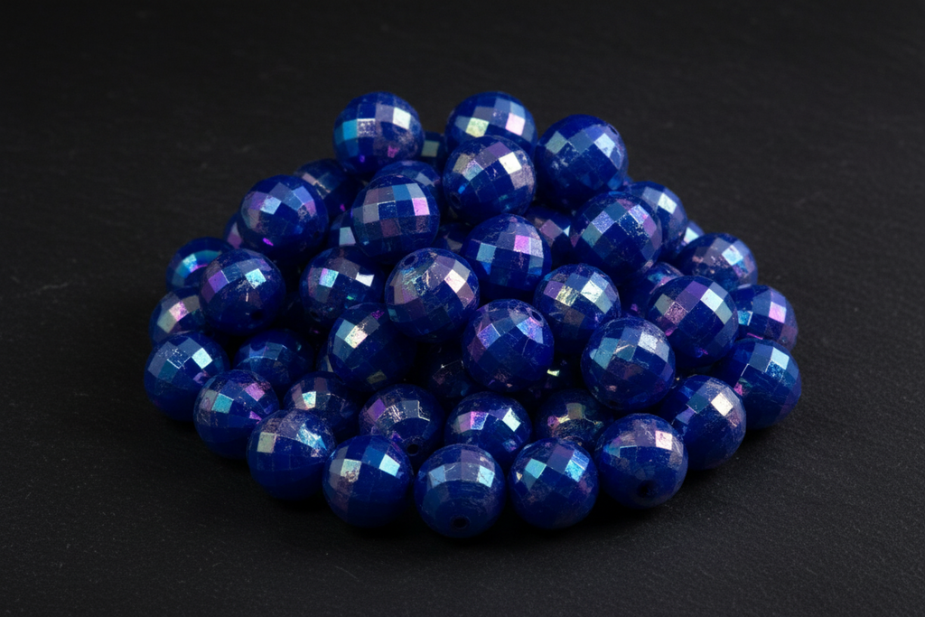 Blue faceted beads on a black background