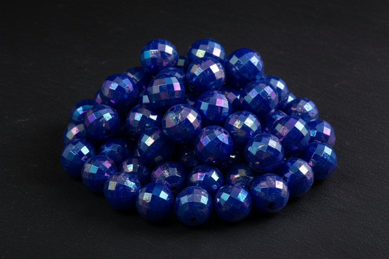 Blue faceted beads on a black background