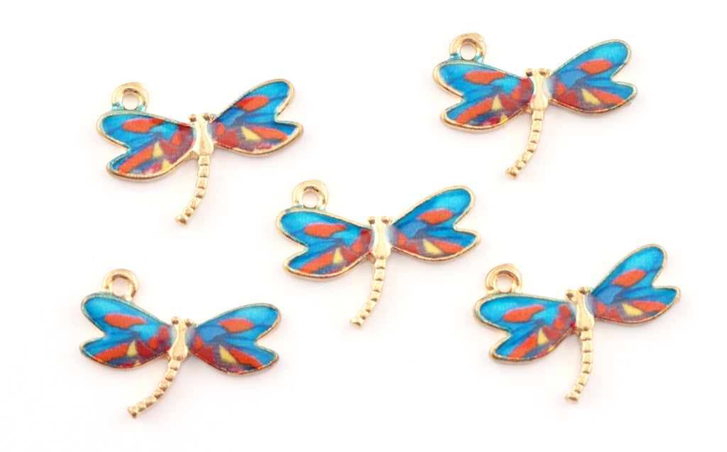 Five dragonfly-shaped jewelry charms with gold-tone metal bodies and wings featuring blue, red, and orange patterns, arranged on a plain white background.
