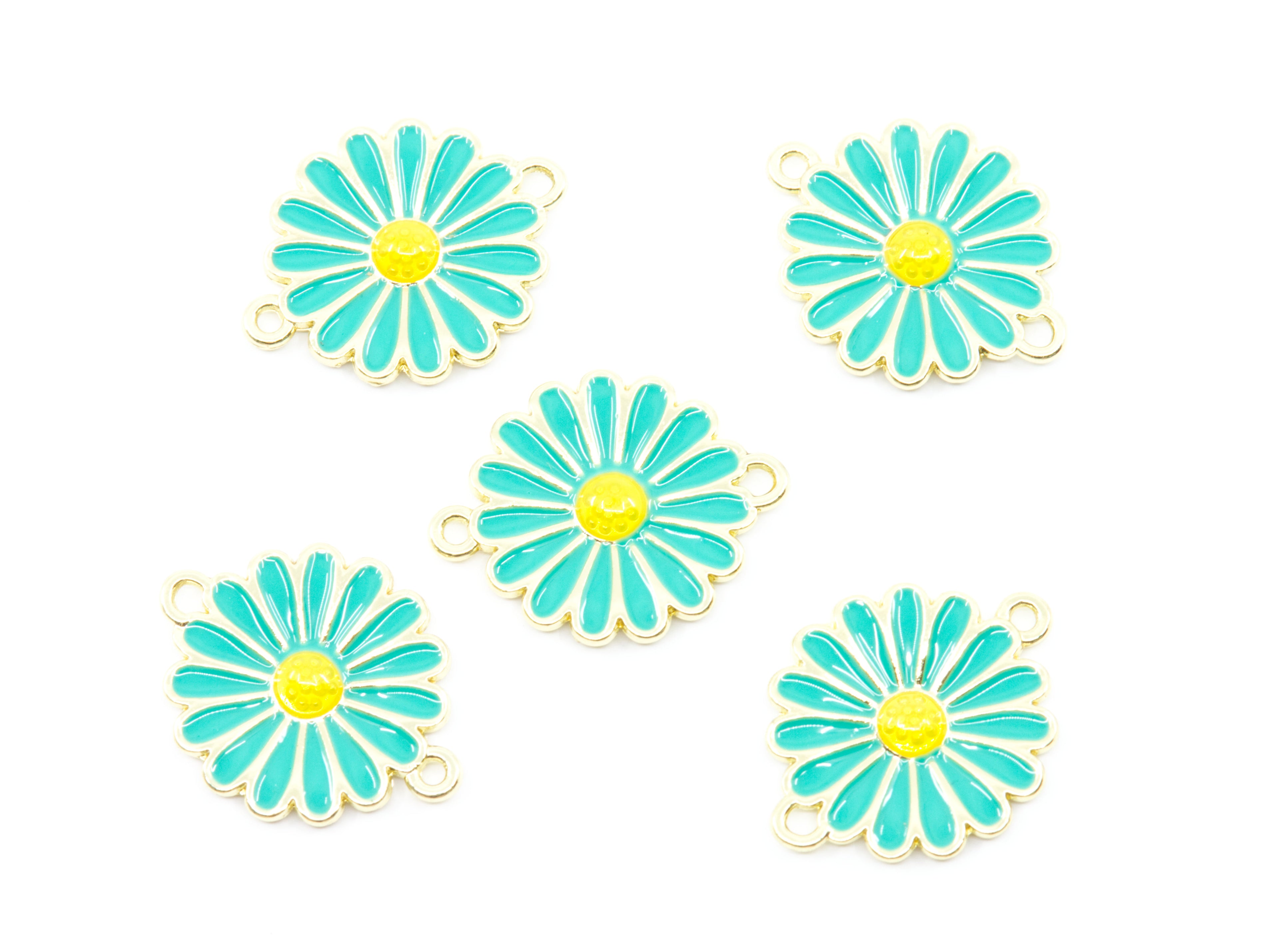 Five blue and yellow enamel daisy flower charms with gold-tone metal borders and small hanging loops, arranged on a plain white background.