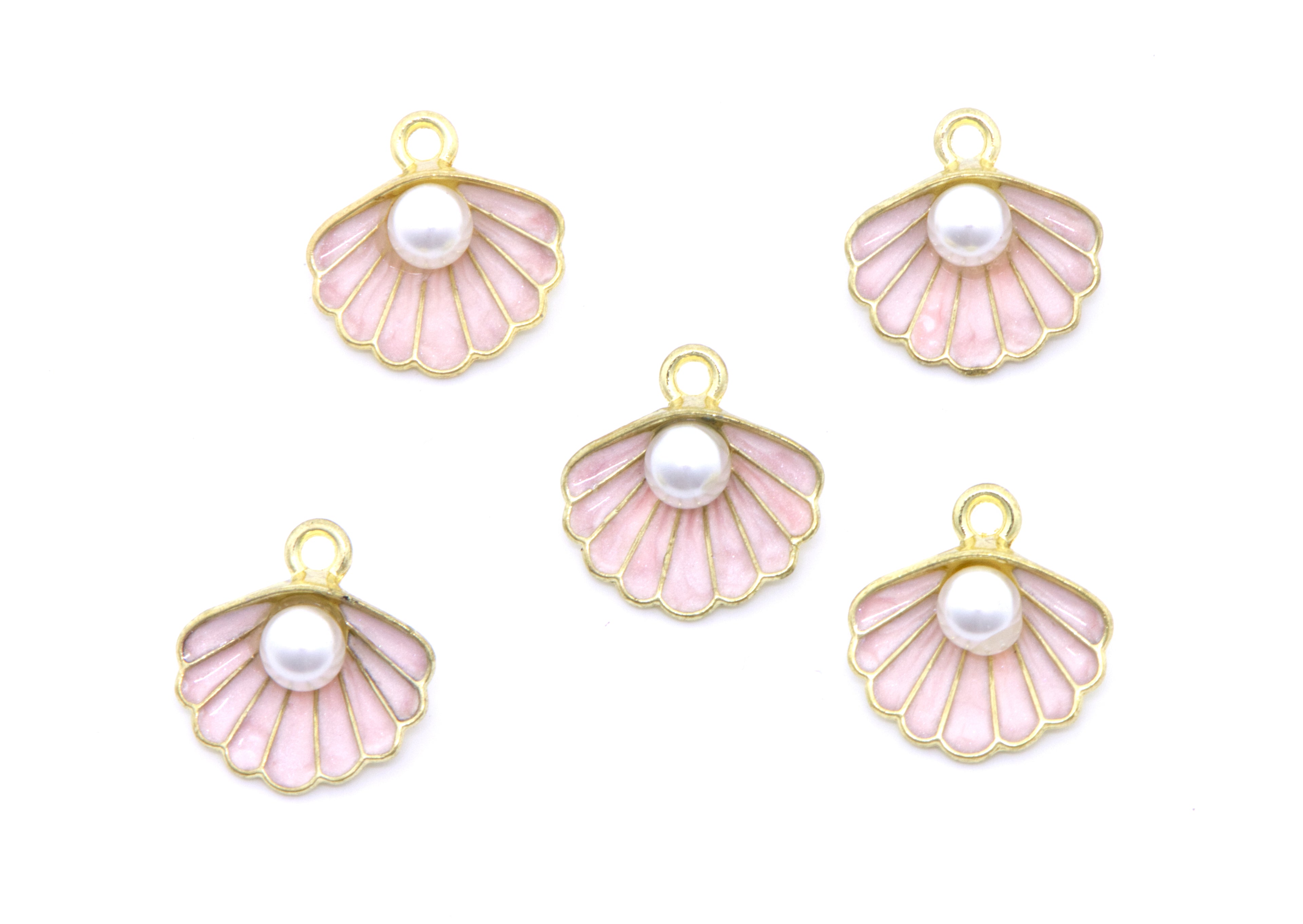 Five gold-plated shell-shaped charms with pale pink enamel inlay and a white faux pearl in the center, arranged on a plain white background.