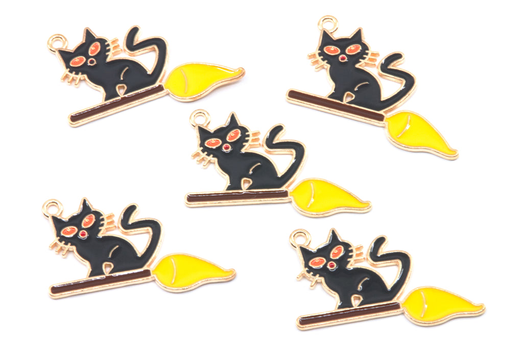 Five identical enamel charms of a black cat sitting on a yellow broomstick, arranged on a plain white background.