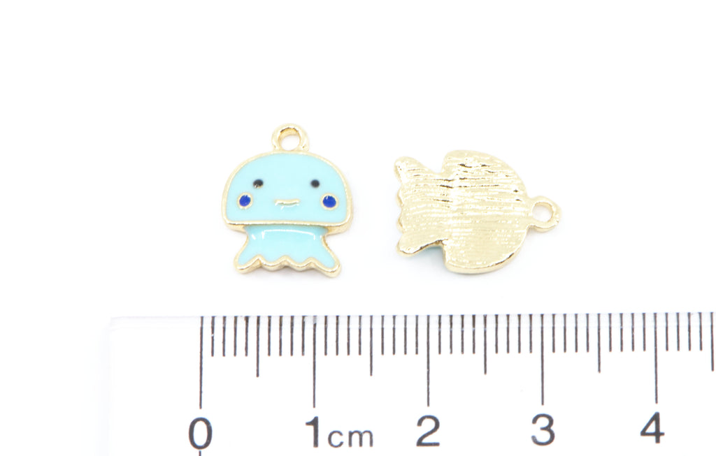 Two small jewelry charms shown on a white background with a ruler at the bottom for scale.