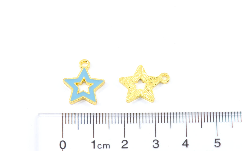 Two small star-shaped jewelry charms,  shown above a ruler for scale on a white background.