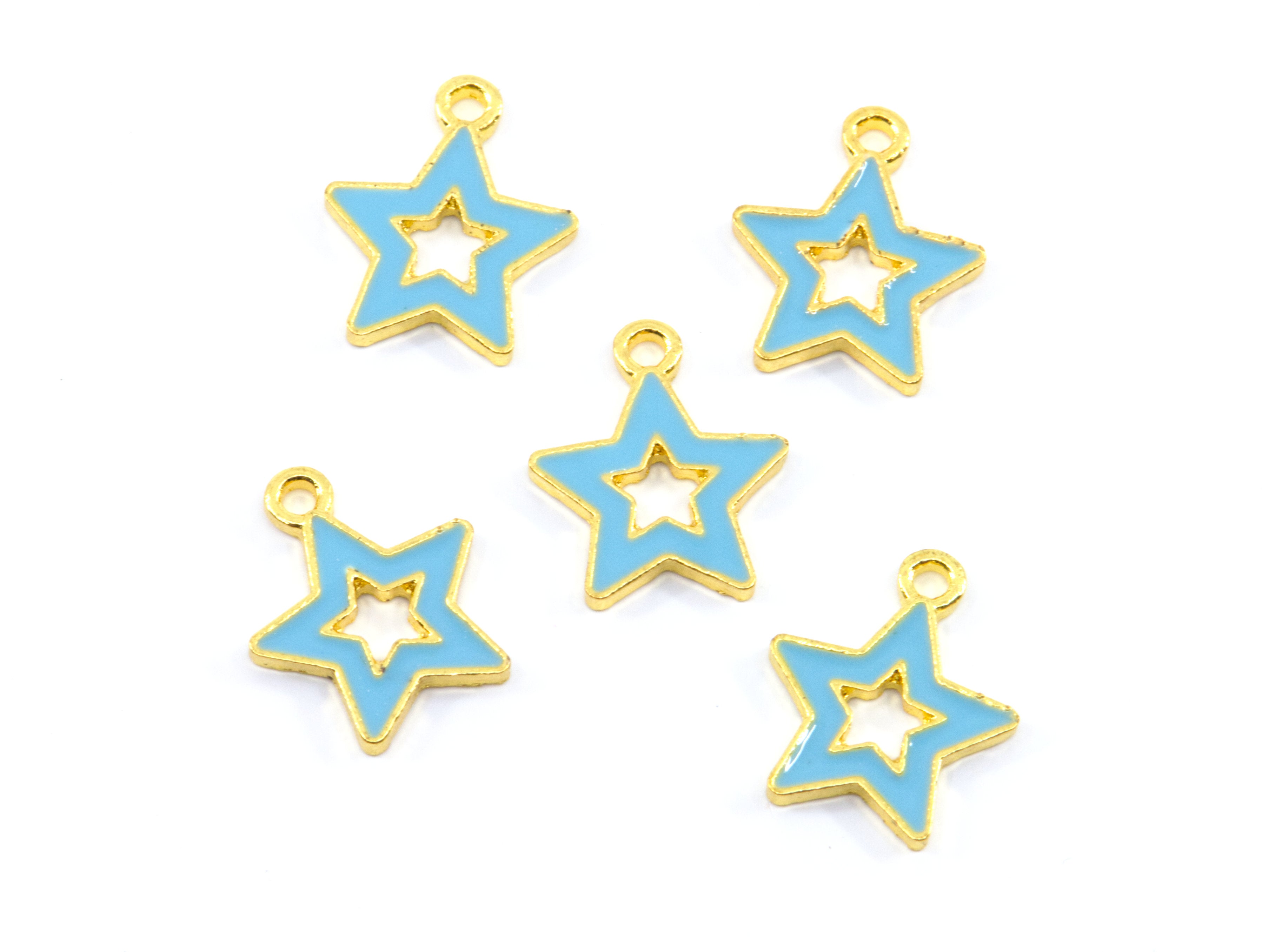 Five star-shaped jewelry charms with light blue enamel and gold-tone metal borders, arranged on a plain white background.