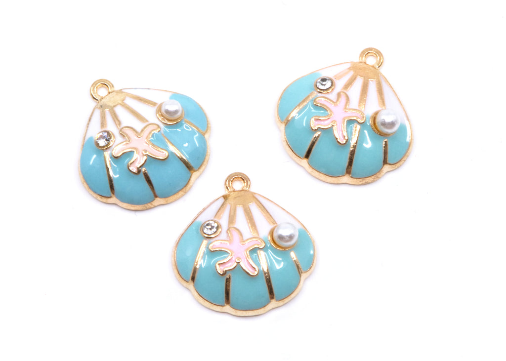 Three seashell-shaped jewelry charms with turquoise blue enamel, gold-tone metal borders, pink starfish details, and small pearl accents on a white background.