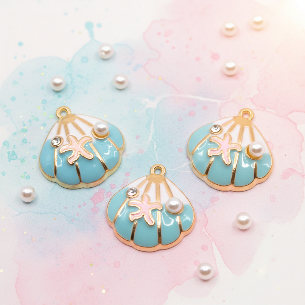 Three seashell-shaped charms with light blue enamel, gold-tone edges, white pearl details, and pink starfish motifs, arranged on a pastel watercolor background with scattered pearl embellishments.