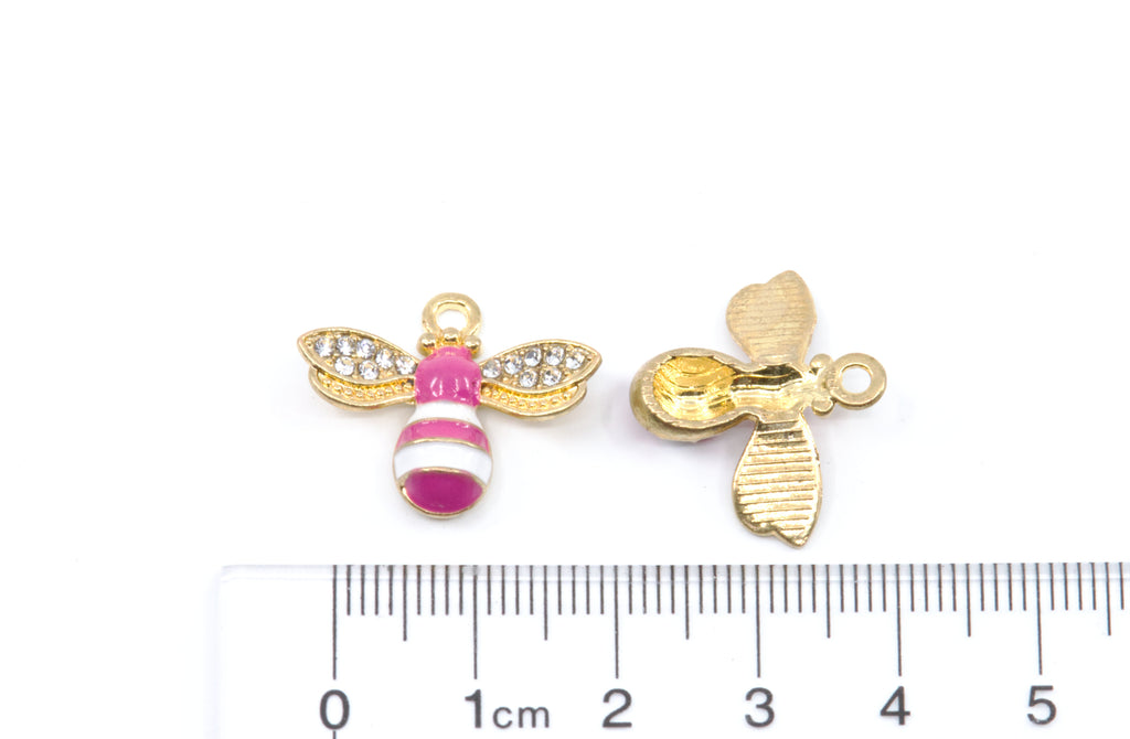Two small bee-shaped jewelry charms on a white background, with a cm ruler below for scale.