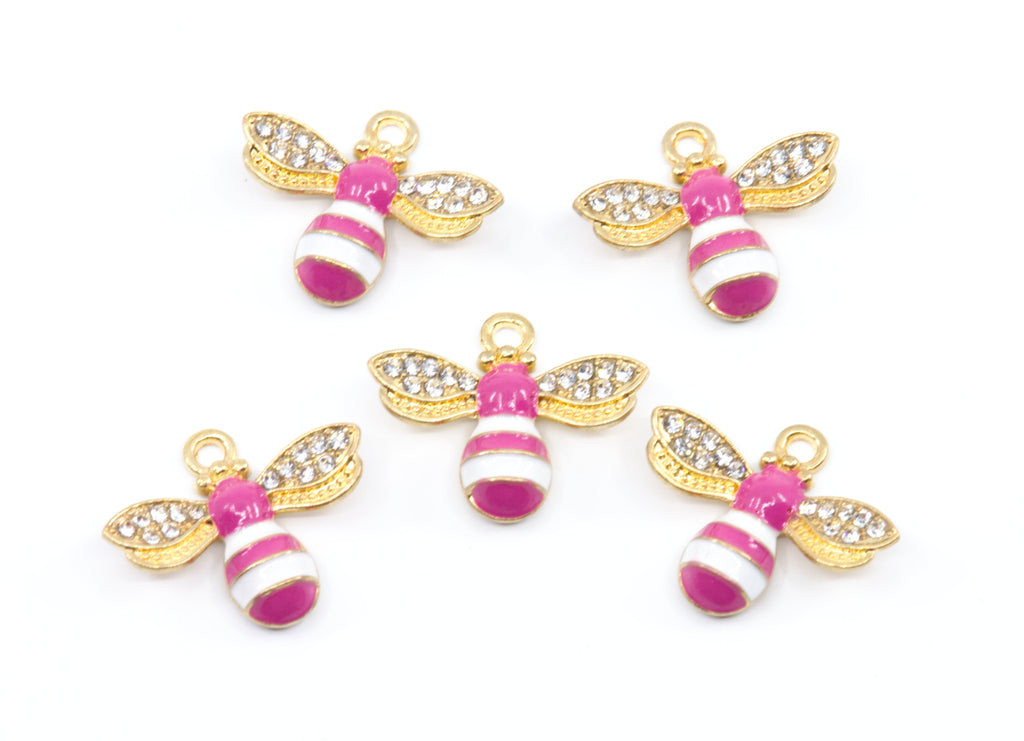 Five gold bee charms with pink and white striped bodies and clear rhinestone wings, arranged on a plain white background.