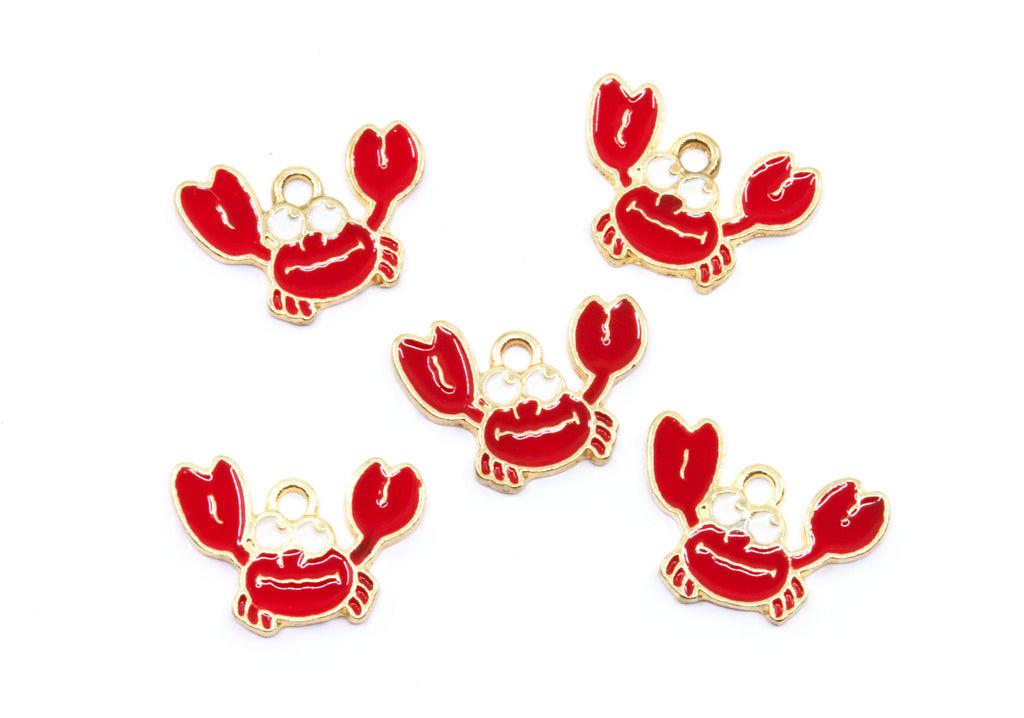 Five red crab charms with gold metal outlines and loops, arranged on a plain white background.