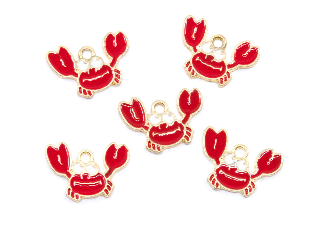 Five red crab charms with gold metal outlines and loops, arranged on a plain white background.
