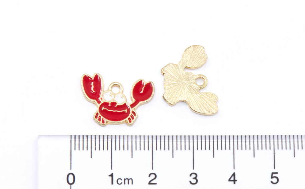 Two red crab enamel jewelry charms on a white background. A cm ruler is shown below for scale.