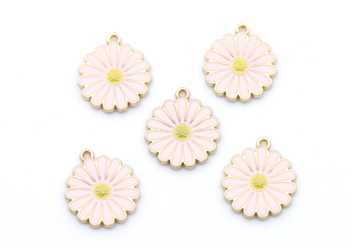 Five pink and gold daisy flower charms with small hanging loops, arranged on a plain white background.