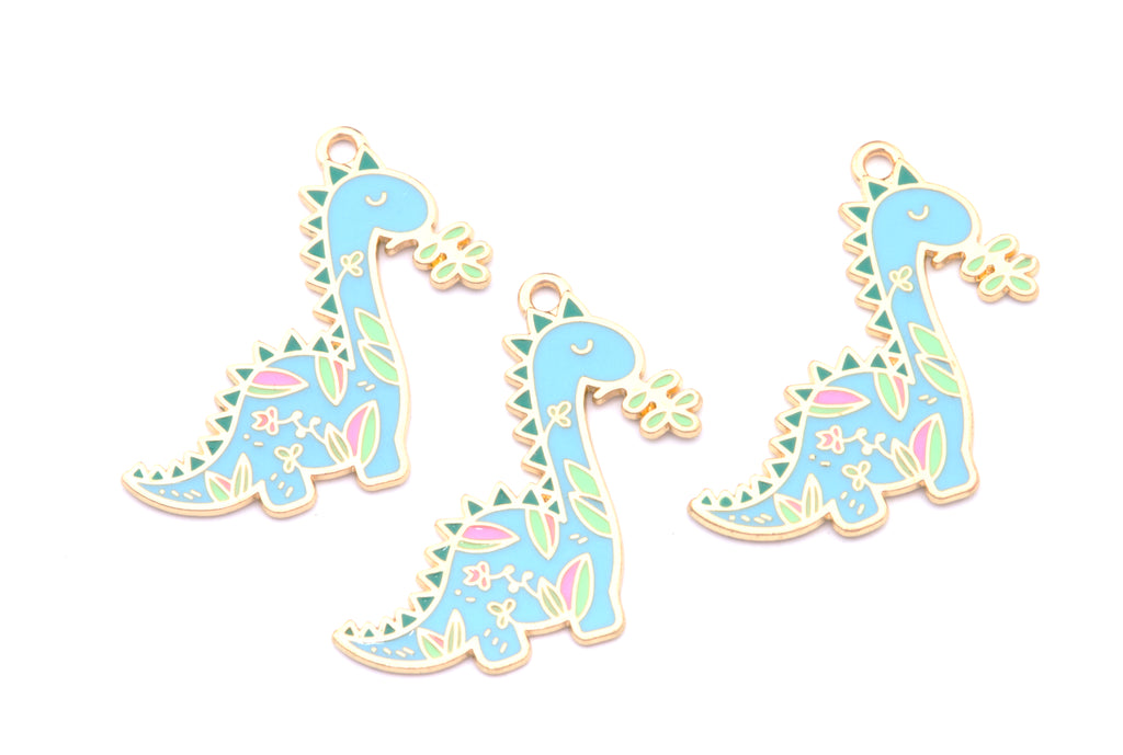 Three matching dinosaur-shaped jewelry charms in light blue enamel with multicolor floral patterns and gold-tone outlines, arranged on a plain white background.