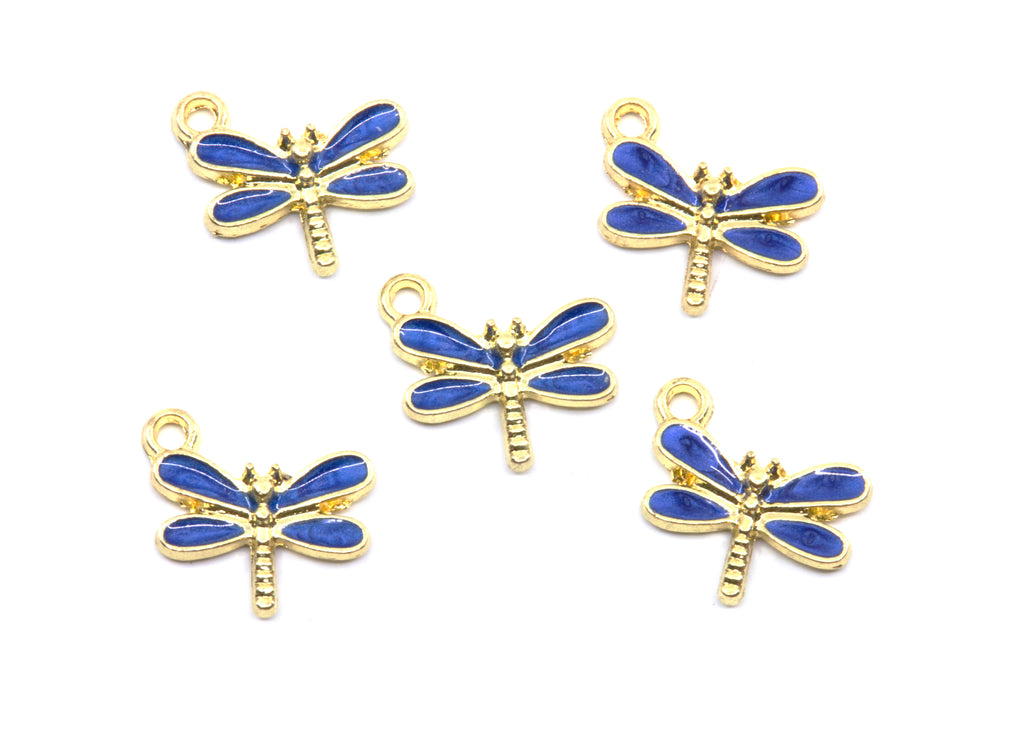 Five dragonfly charms with blue enamel wings and gold-tone metal bodies, arranged on a plain white background.