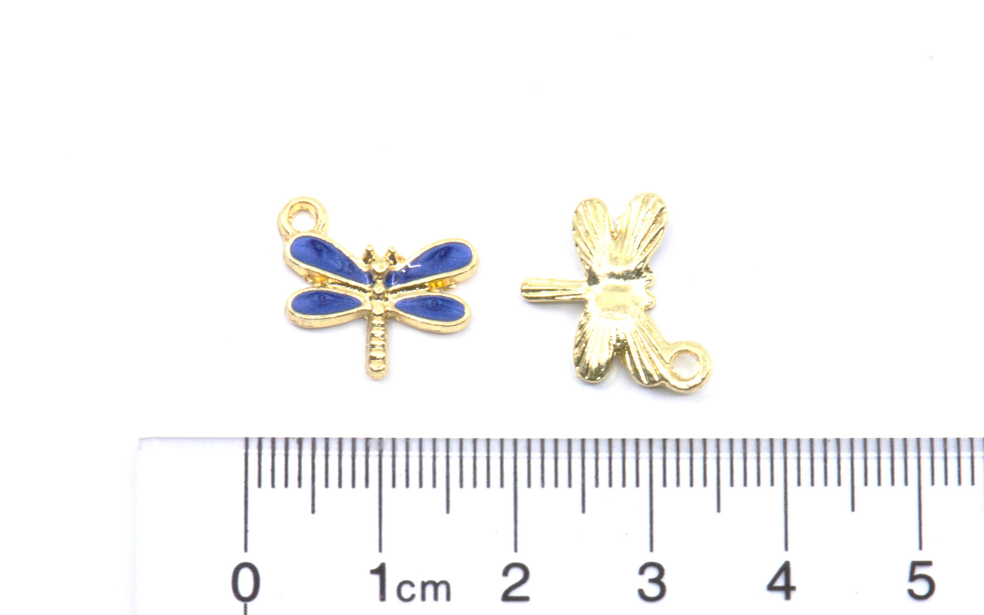 Two small dragonfly-shaped jewelry findings or charms shown on a white background, one front view with blue enamel wings and one back view, with a cm ruler below for scale.