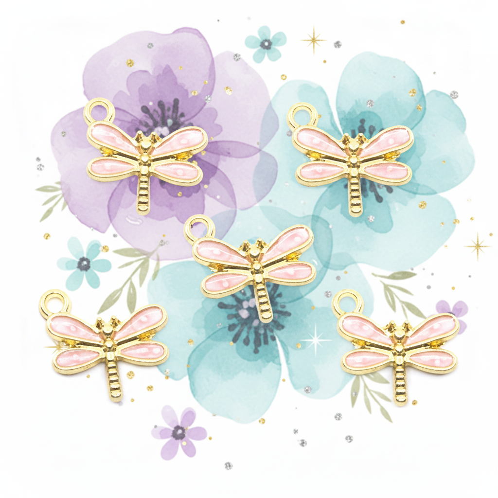 Five dragonfly-shaped jewelry charms with pink enamel wings and gold-tone bodies, arranged on a white background with large watercolor flowers and small decorative sparkles.