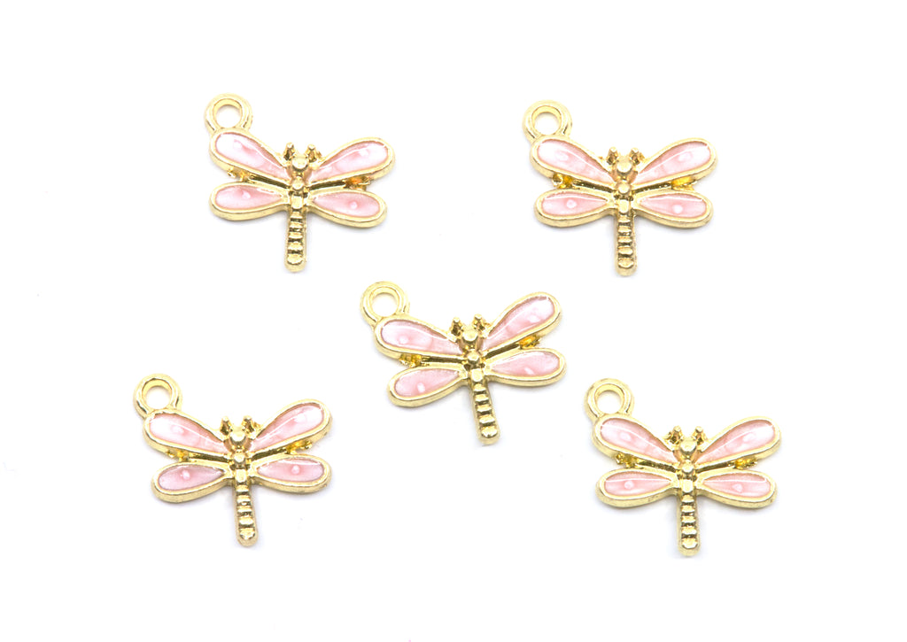 Five dragonfly charms with pink enamel wings and gold-tone metal bodies, arranged on a plain white background.