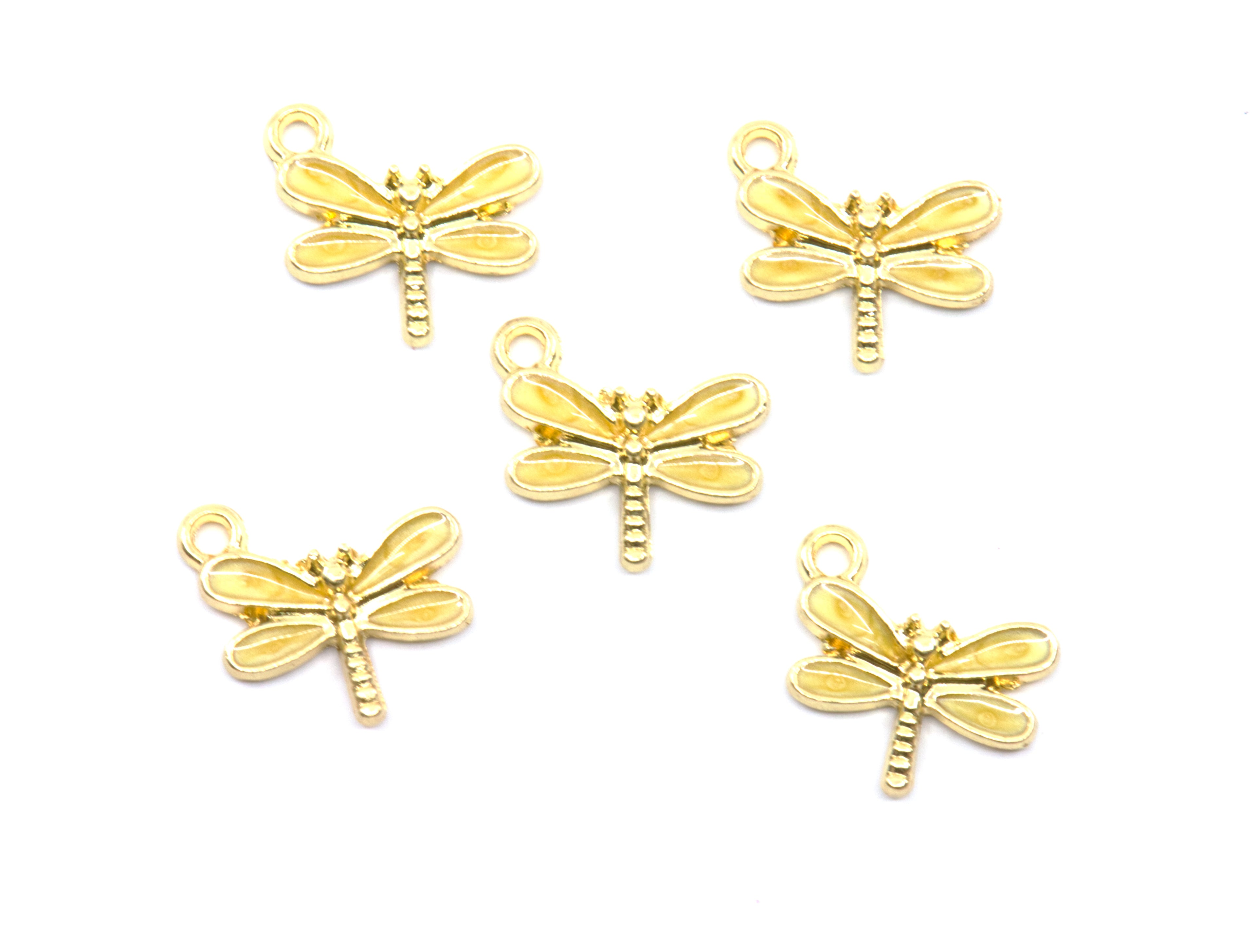 Five yellow dragonfly charms with small hanging loops, arranged on a plain white background.