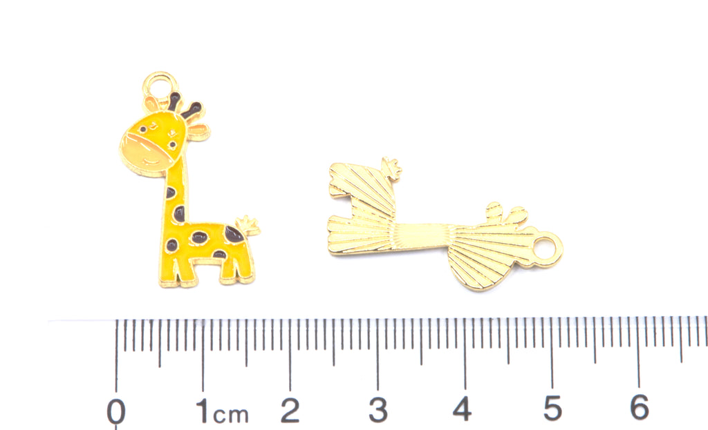 Two yellow giraffe gold-tone jewelry charms, displayed above a cm ruler on a white background.