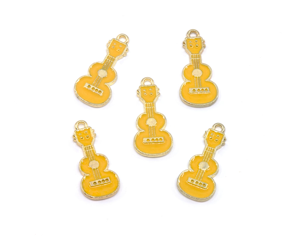 Five small guitar-shaped jewelry charms in  yellow enamel with gold-tone metal edges and loops, arranged on a plain white background.