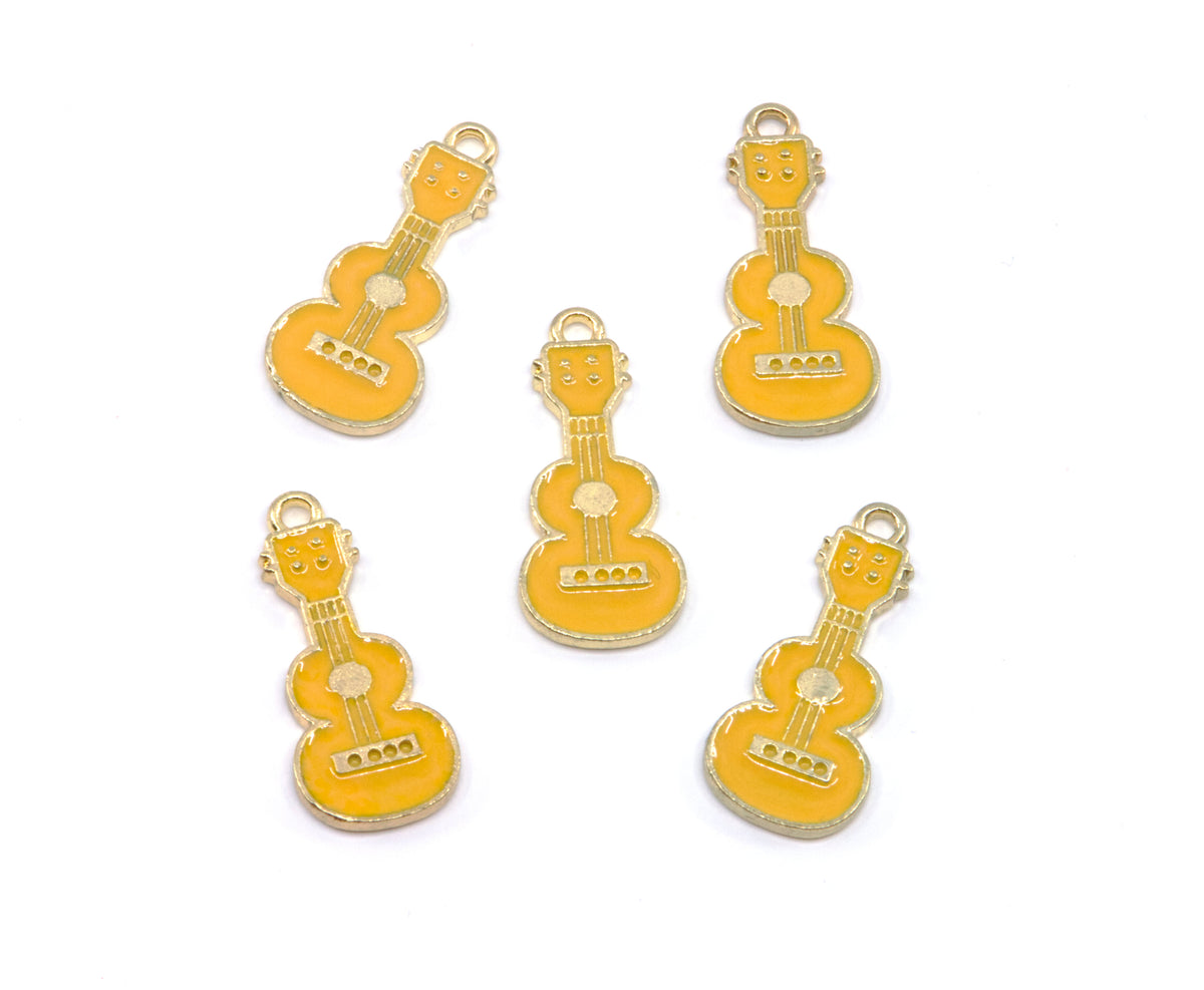 Five small guitar-shaped jewelry charms in  yellow enamel with gold-tone metal edges and loops, arranged on a plain white background.